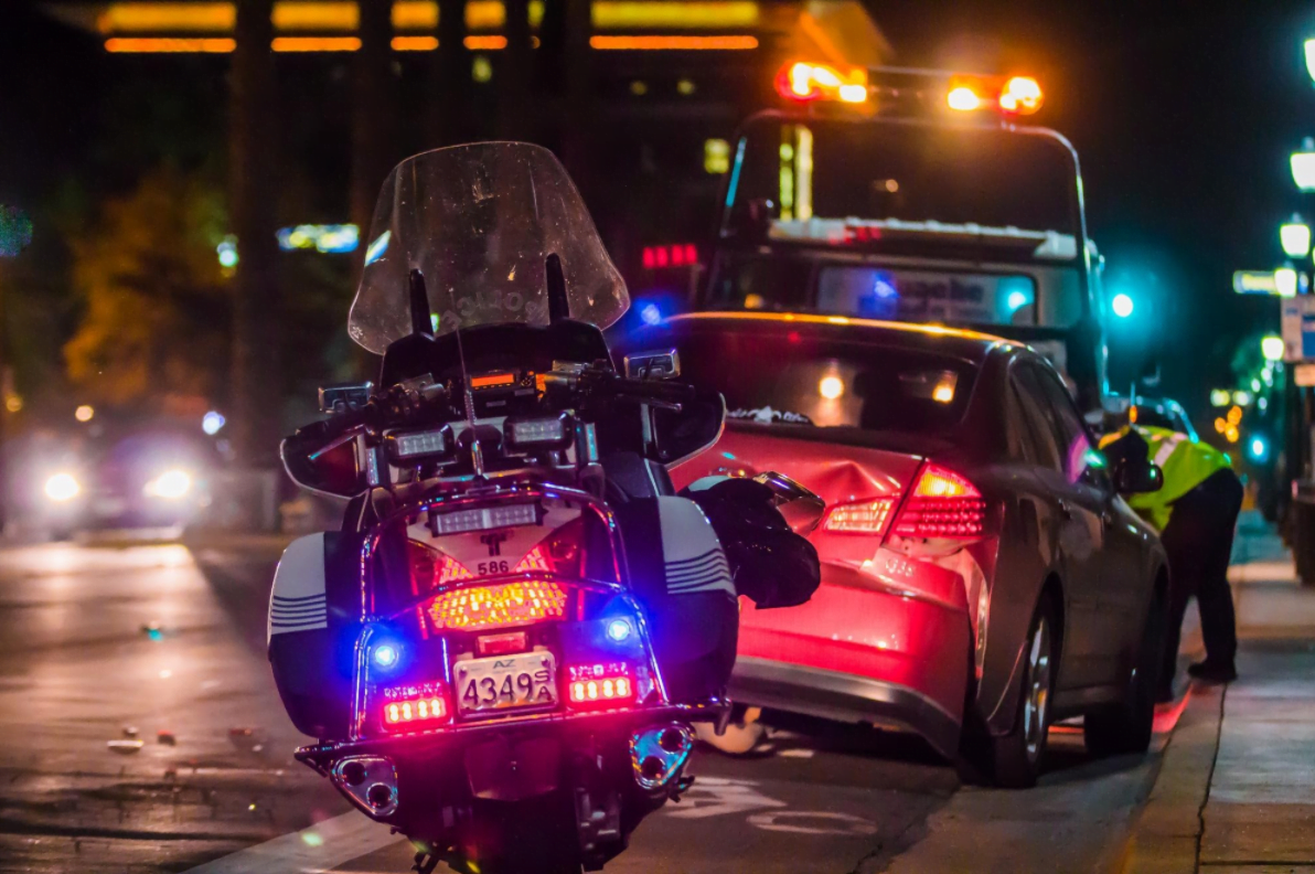 Police vehicle and damaged car illustrating accident risk reduction with autonomous vehicles.