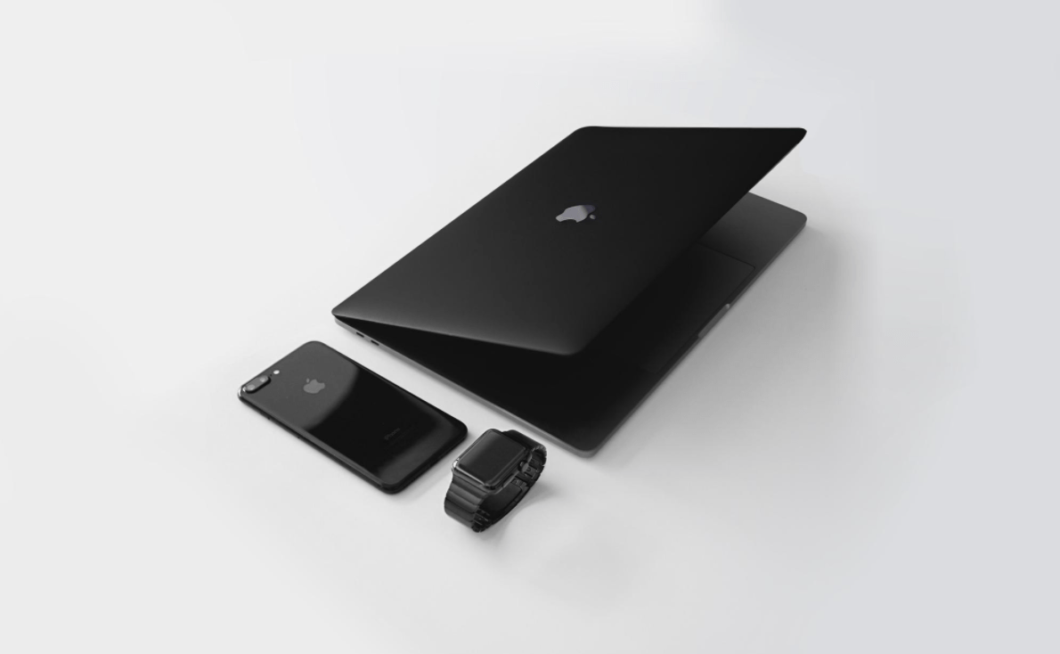 Apple devices including laptop, smartphone, and smartwatch illustrating technology integration.